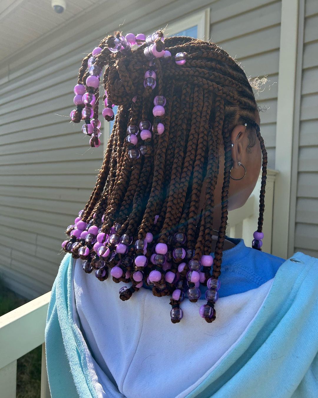 31. Brown Half Up Half Down Knotless Braids With Purple Beads